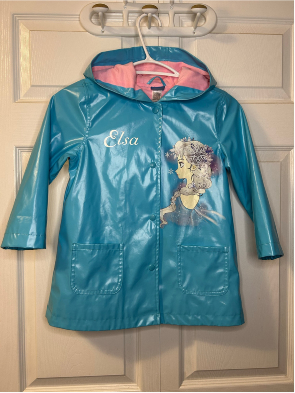 Disney Frozen Elsa Girls Raincoat, a glossy blue waterproof vinyl jacket with a